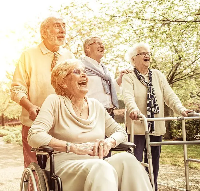 group of four seniors smiling and happy